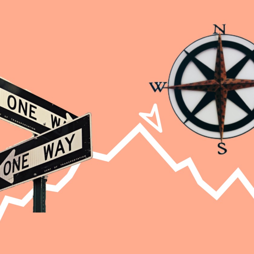 One way signs and compass next to stock market line chart.